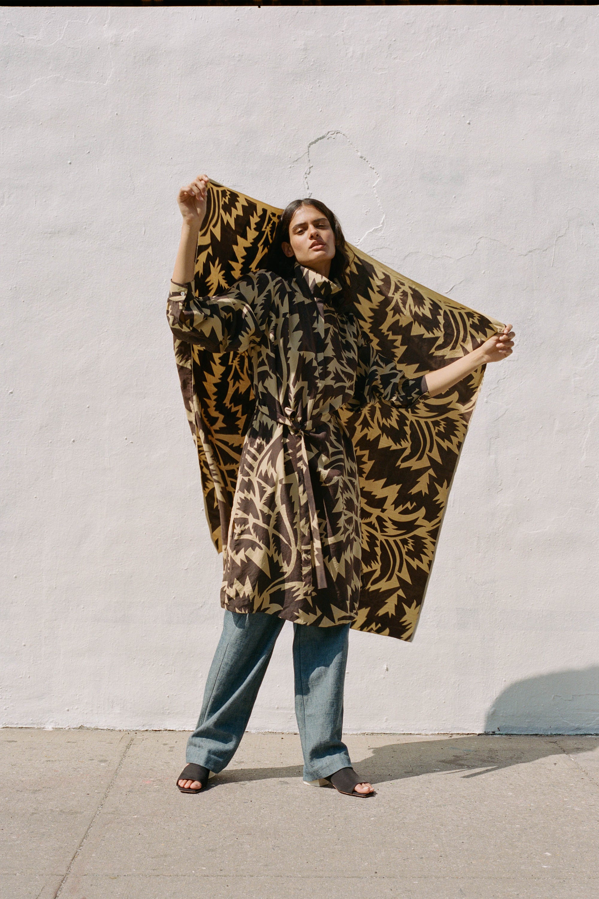 A woman wearing funnel neck silk shirt dress